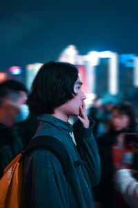 Portrait of a woman looking away at night