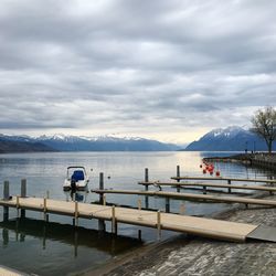 Scenic view of lake geneva against cloudy sky