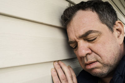 Close-up portrait of a man with eyes closed