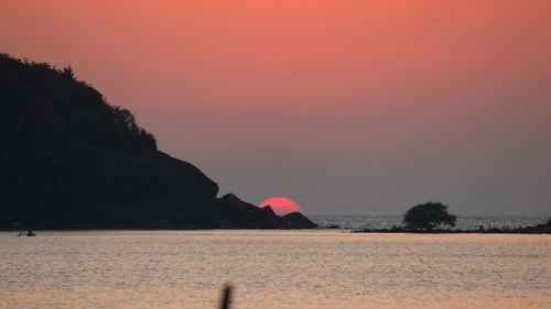 Scenic view of sea against clear sky at sunset