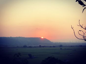 Scenic view of field against sky during sunset