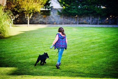 Full length of a man walking with dog