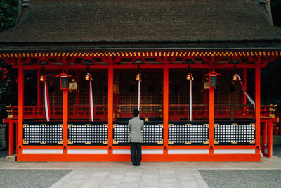 Rear view of a man walking in temple