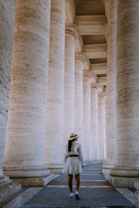 Full length of woman standing at historic building