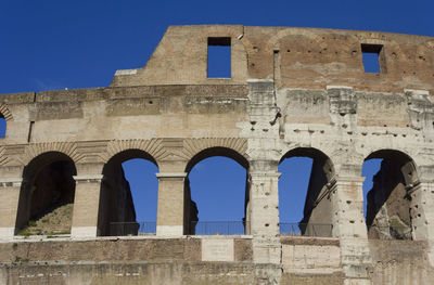 Low angle view of historical building against blue sky