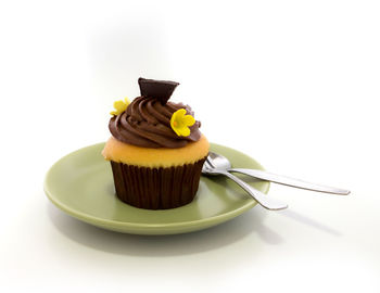 Cup of cake on plate against white background