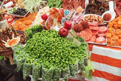 High angle view of fruits and candy  for sale in market