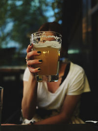 Midsection of woman holding drink