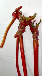 Close-up of red chili pepper on white wall