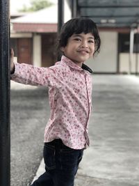 Portrait of smiling girl standing outdoors