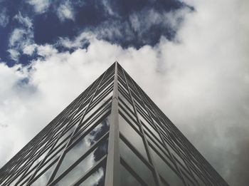 Low angle view of modern building against cloudy sky