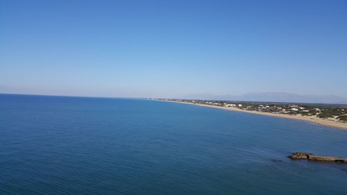 Scenic view of sea against clear blue sky