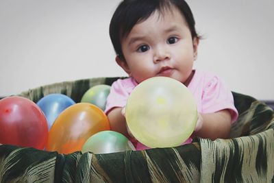 Portrait of cute boy holding balloons