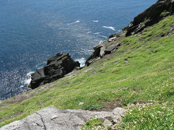 High angle view of cliff by sea against sky