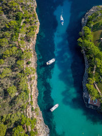 Aerial view of boats in beautiful sea bay, cala mitjana, mallorca, spain