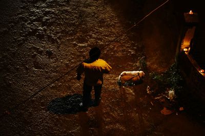 Rear view of man with umbrella