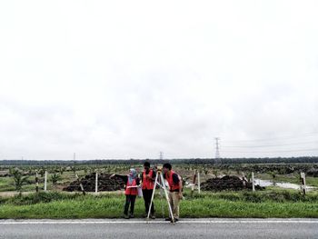 Rear view of people walking on road