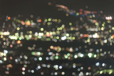 Defocused image of illuminated city at night