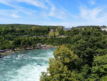 High angle view of river amidst trees against sky