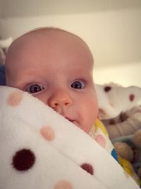 Portrait of cute baby lying on bed