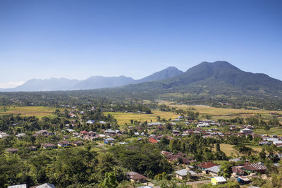 Scenic view of landscape and mountains against clear sky