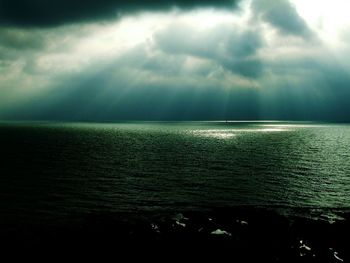 Scenic view of sea against storm clouds