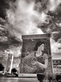 Low angle view of statue against building against sky