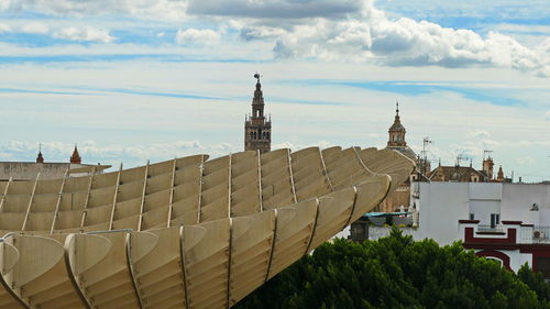 View of buildings against cloudy sky