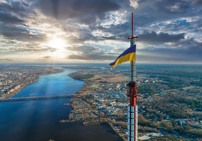 Aerial view of the ukrainian flag waving on top of the riga tv tower