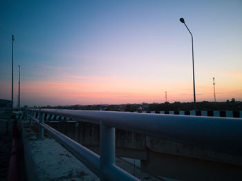 Silhouette bridge against sky during sunset
