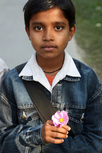 Portrait of boy holding flower bouquet