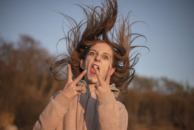 Portrait of young woman standing outdoors