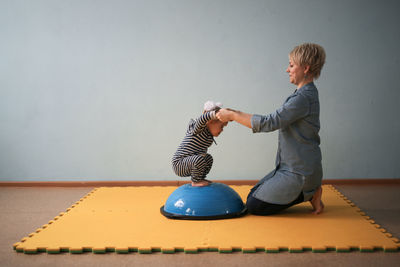 Portrait of young woman exercising on floor at home
