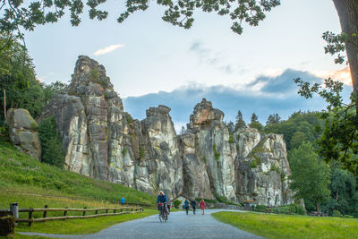 People on road against mountains