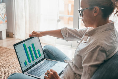 Side view of man using laptop at office