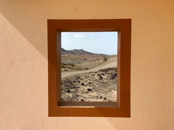 Scenic view of desert seen through window