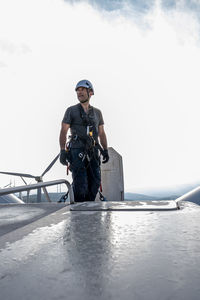 Portrait of ropeaccess technician on the top of windmill