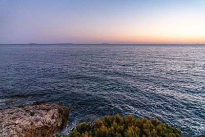 Scenic view of sea against clear sky during sunset