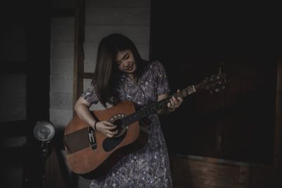 Young woman playing guitar