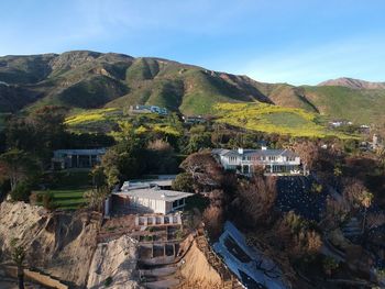 High angle view of buildings and trees against sky