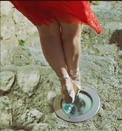 Low section of woman standing on tiled floor