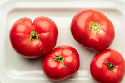 High angle view of tomatoes in plate on table