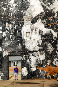 Man standing by building in city