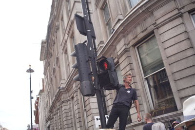 Low angle view of man standing on street