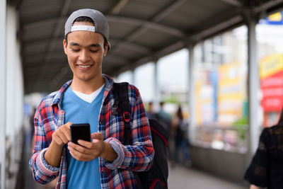 Portrait of young man using mobile phone