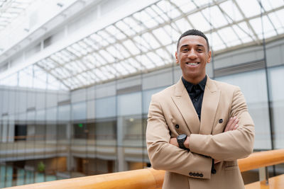 Portrait of young man standing in city