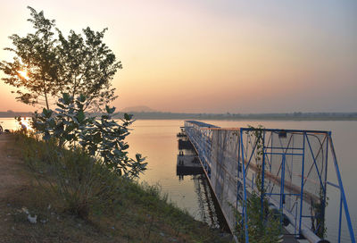 Scenic view of lake against clear sky during sunset