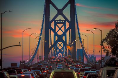 Traffic on road at sunset