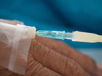 Close-up of man with iv drip at hospital