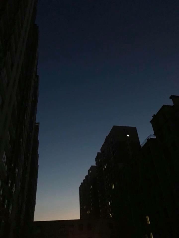 LOW ANGLE VIEW OF ILLUMINATED BUILDINGS AGAINST SKY